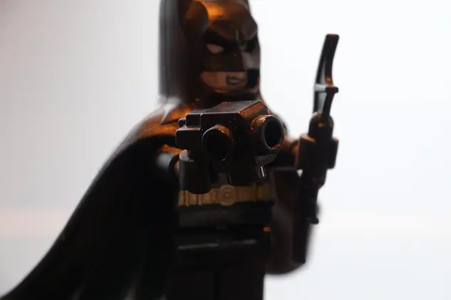 LEGO Batman with a grappling gun, aimed at you